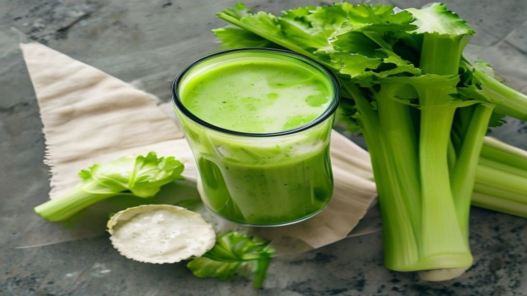 Straining Celery Juice Top-down view of the celery juice straining process.