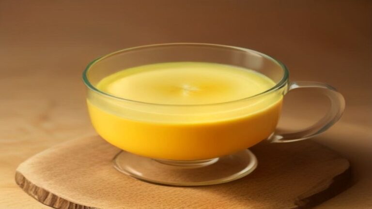 A steaming mug of golden milk turmeric latte with a dusting of cinnamon.